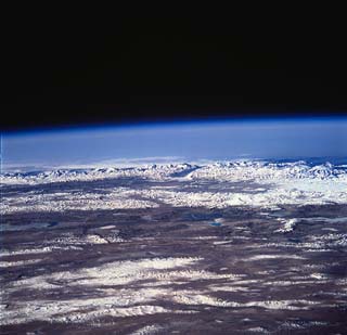 Profile view of the Himalayan Range and Mt. Everest of Nepal with the Tibetan Plateau in the foreground.